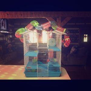 A used hamster cage with some accessories